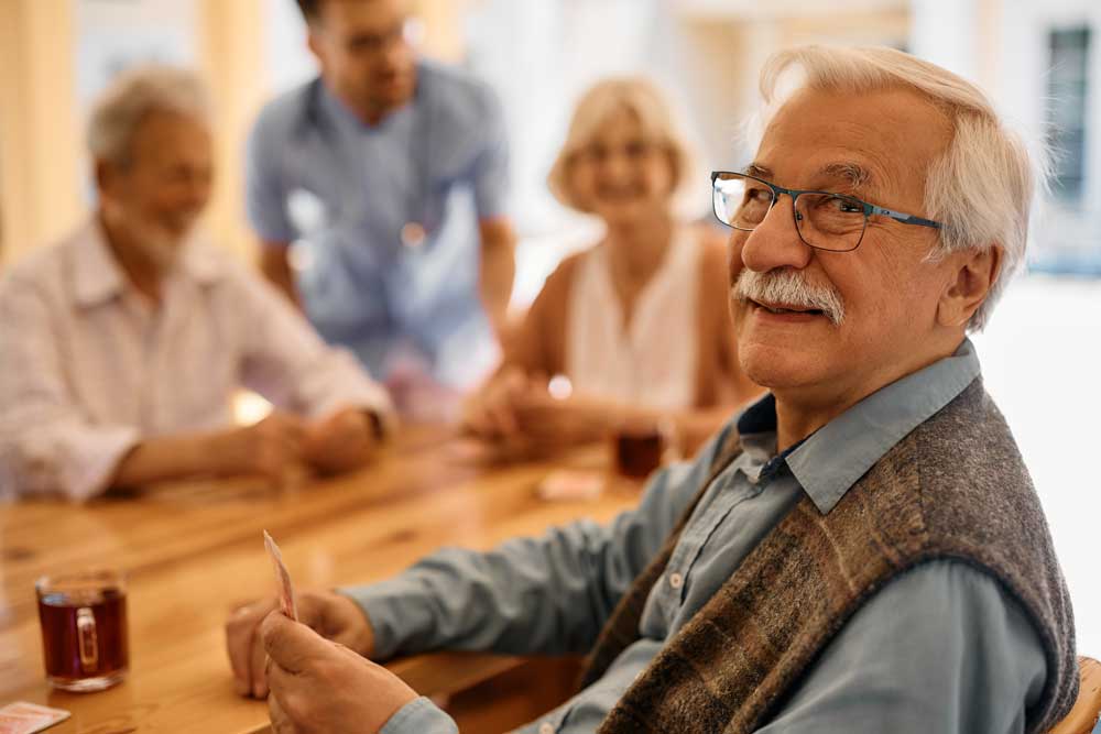 memory care along the journey image, group playing cards